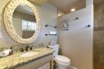 The two downstairs bedrooms share a bathroom with a beautiful, step-in tumbled tile shower.